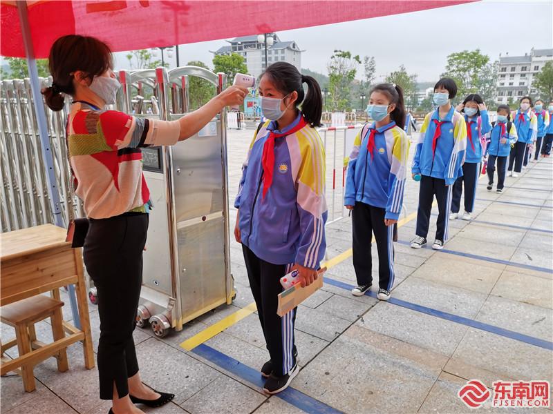 泰寧縣文昌小學的學生進入學校前 正在排隊進行測量體溫 熊明歡 攝.jpg